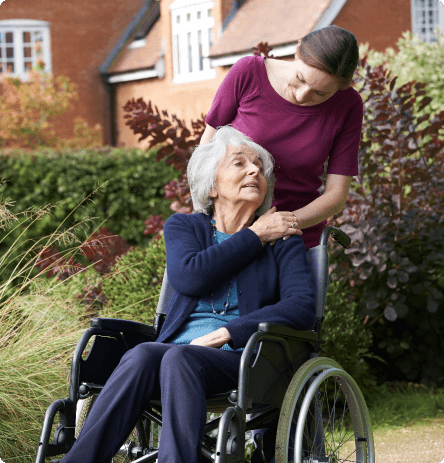 elder care provider helps woman in wheelchair