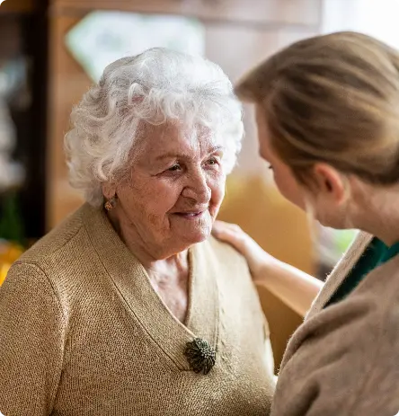 A caregiver speaks to an elderly client
