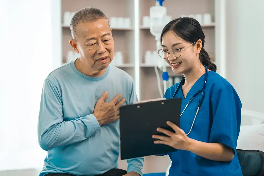 An elderly man in an appointment with a healthcare worker.